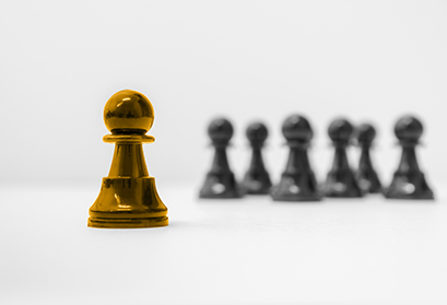 Image of Golden Chess Piece standing out amongst other chess pieces (Top Workplaces Award)