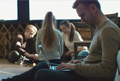 What is Work-Life Flexibility, image of employee on laptop with family in background
